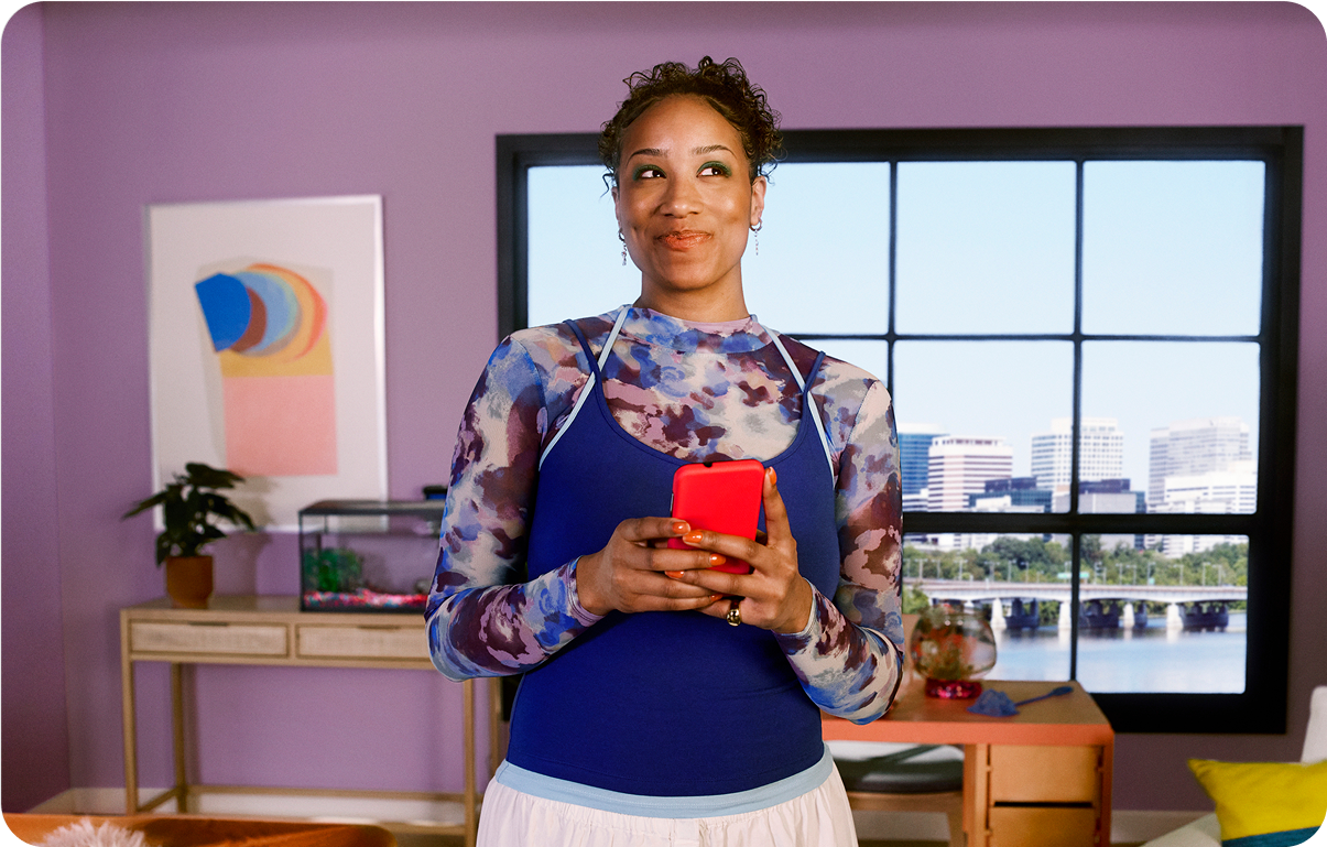 image of woman holding a phone looking off into the distance