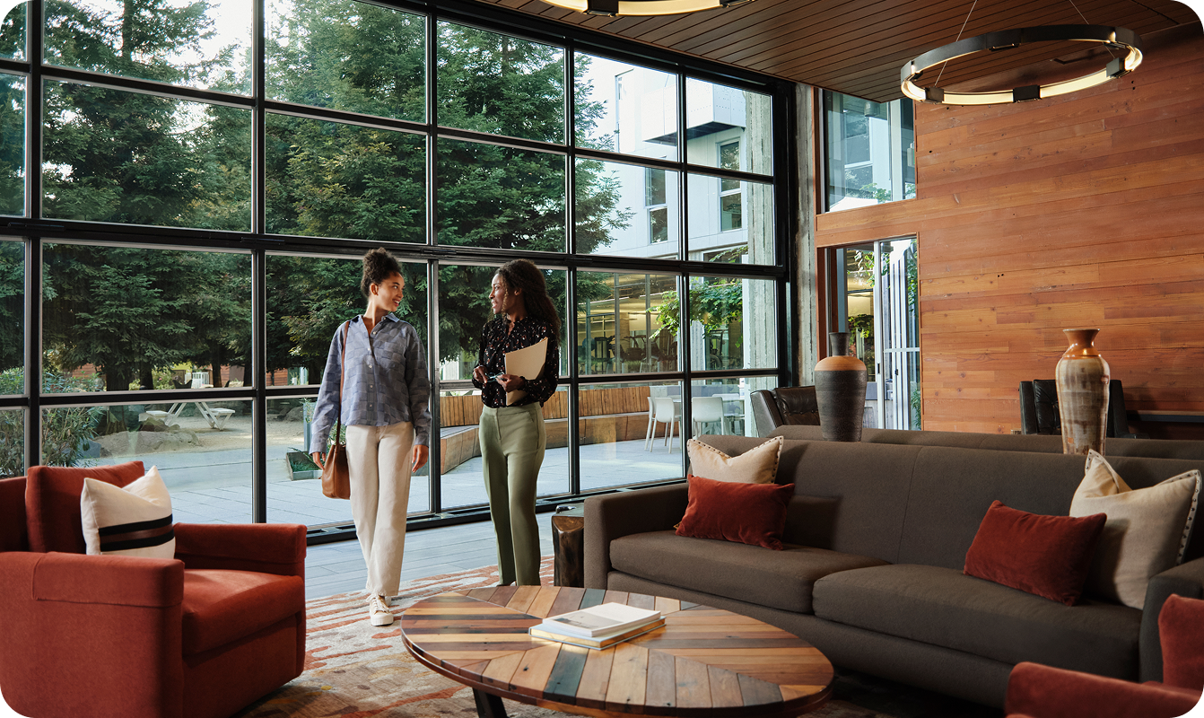 two women in an office building walking