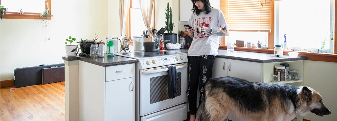 image of woman in a kitchen with a dog