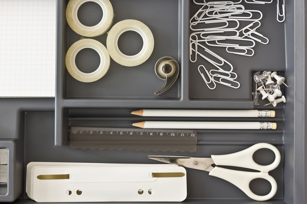 organized drawer with scissors, paperclips, and pens