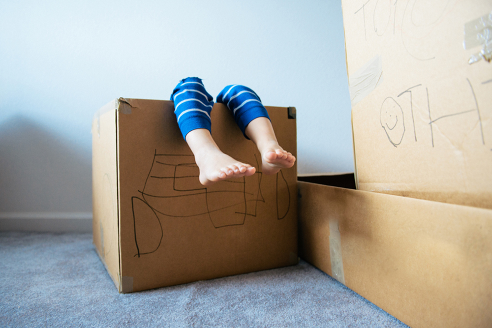 Child in Cardboard Box