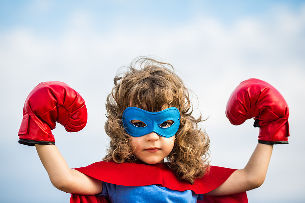 little girl dressed as a superhero