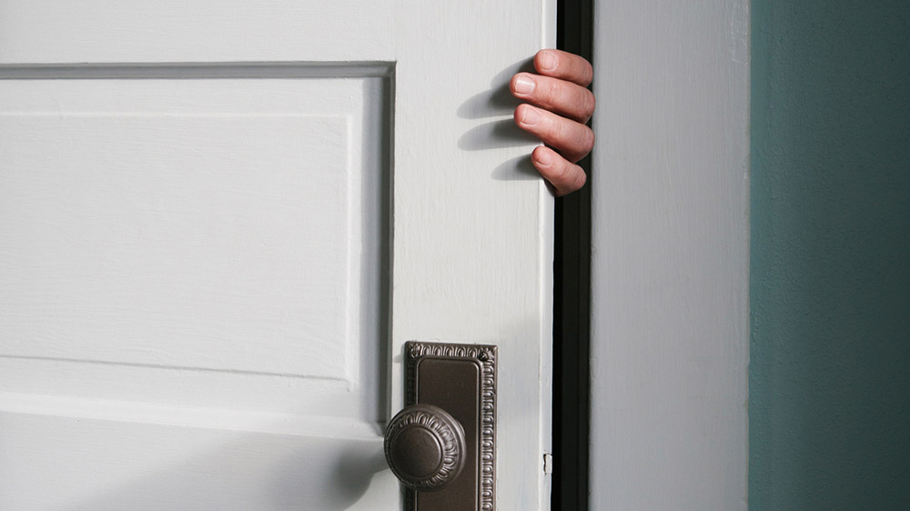 Hand opening door before security assessment