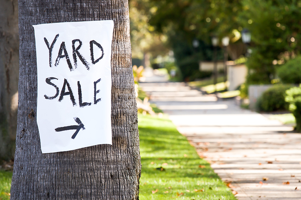 yard sale sign on tree