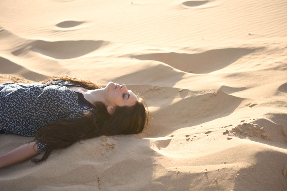woman relaxing in sand