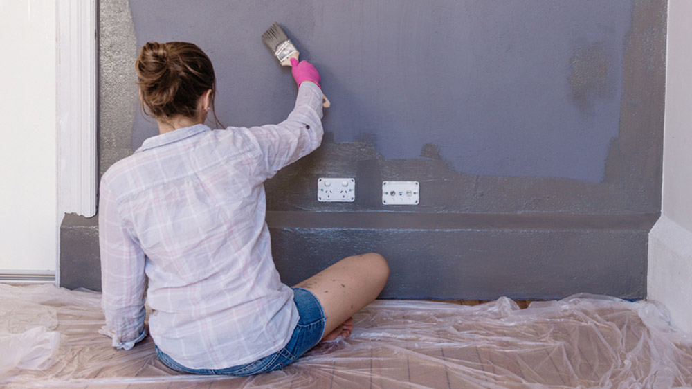 woman painting house home makeover