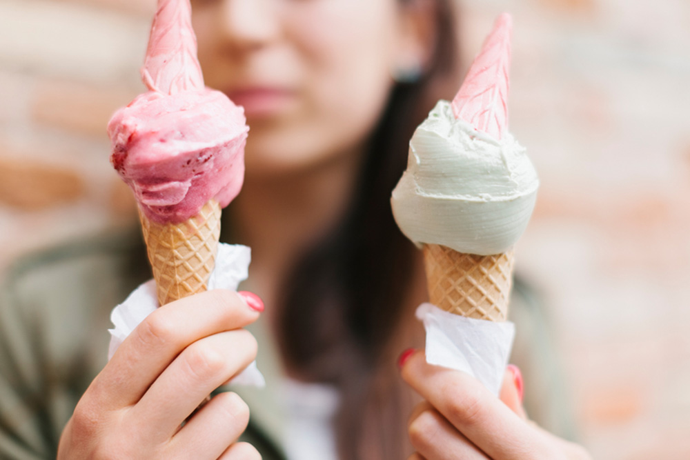 girl holding two ice cream cones