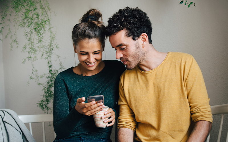 Couple browsing Zillow on a phone