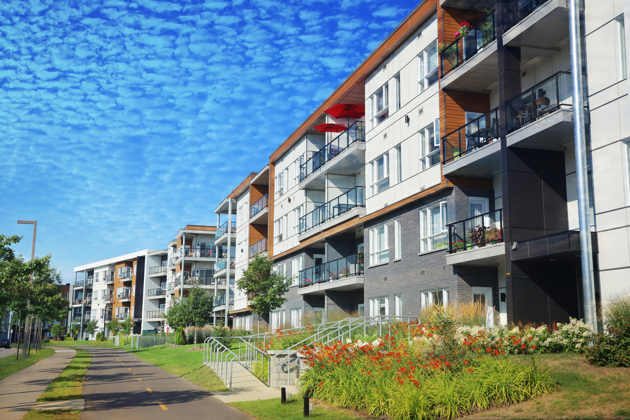 4-story apartment building with walking path and wheelchair accessible ramp