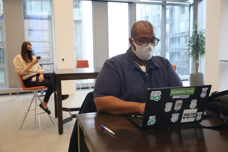 Zillow employee works on a laptop in the office