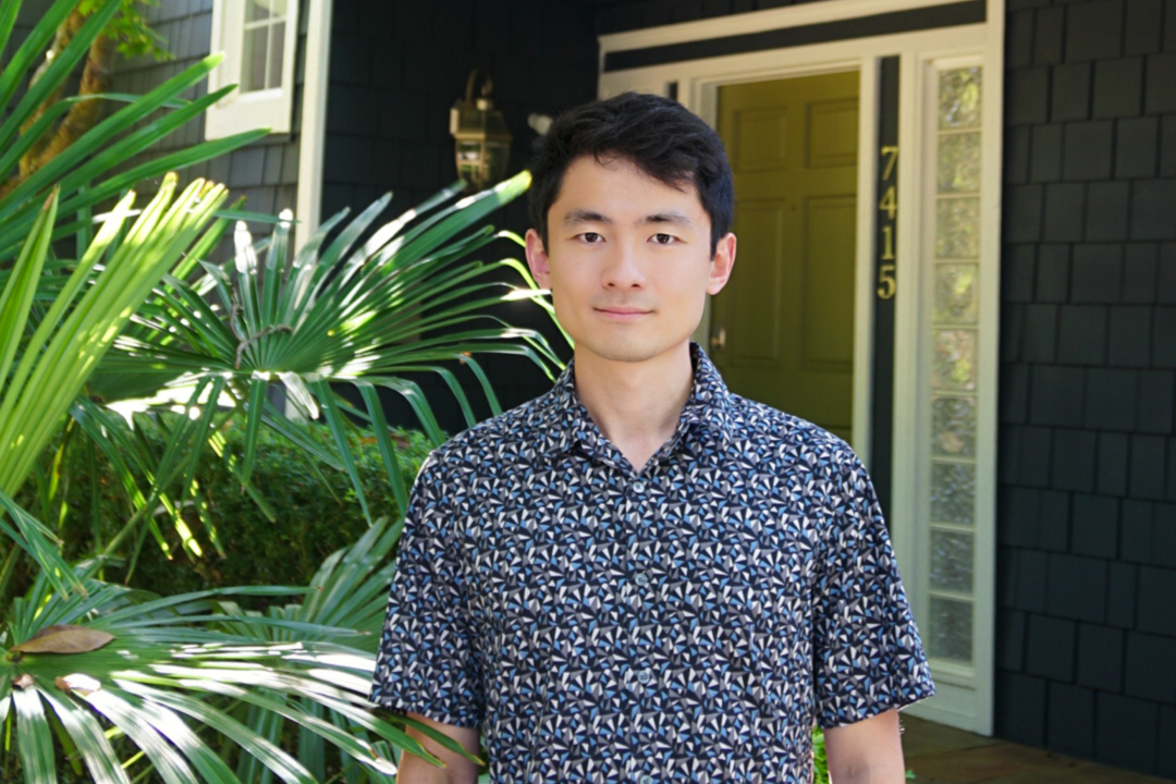 Zillow Applied Scientist Yuguang Li standing in front of a home