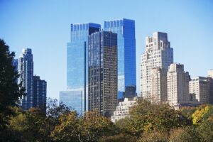 tall buildings rise above Central Park co-op vs. condo