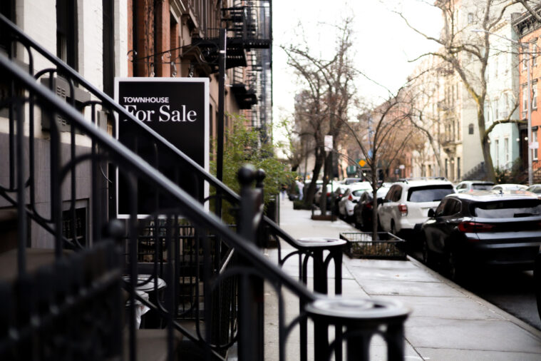 townhouse for sale sign on NYC block - cost to sell a home in NYC