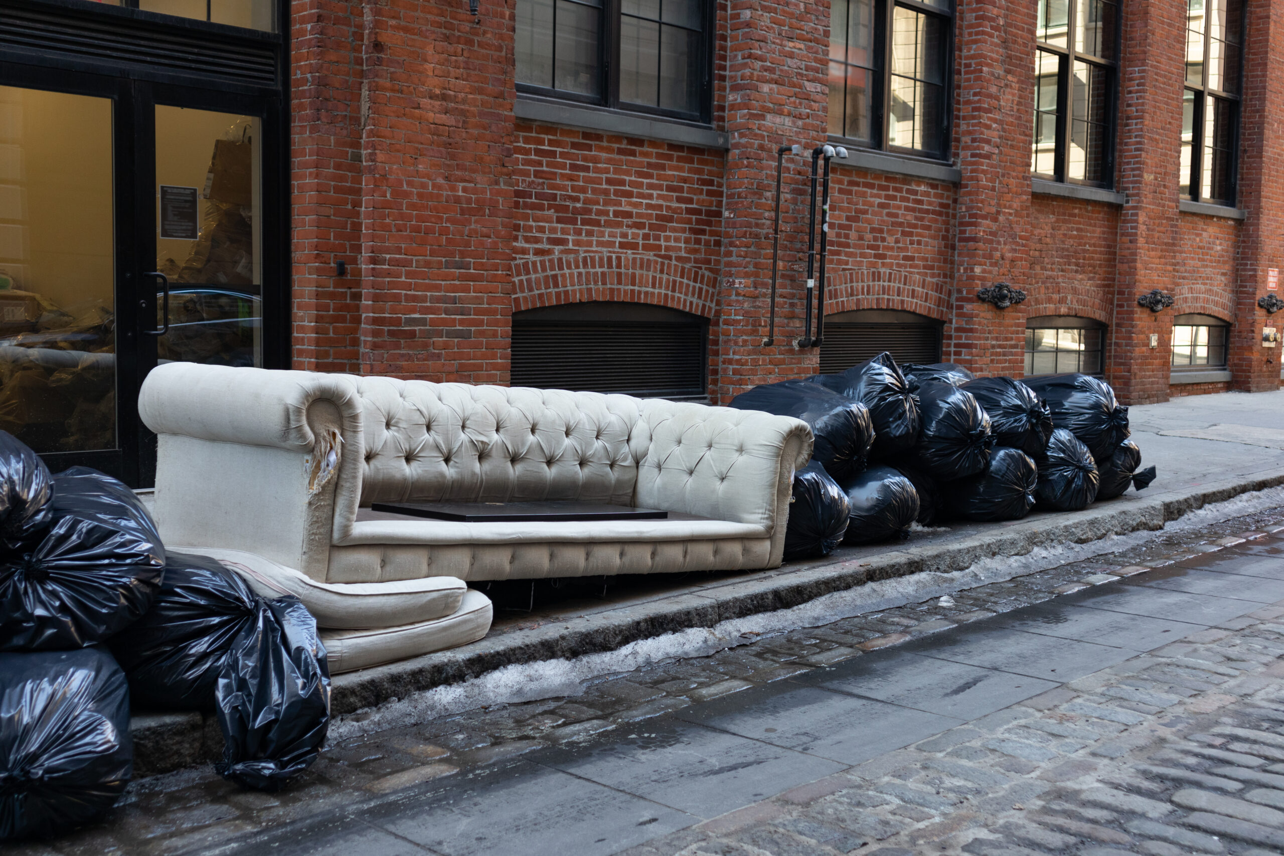 Black Trash Bags Along A Street And Sidewalk In Greenwich Village