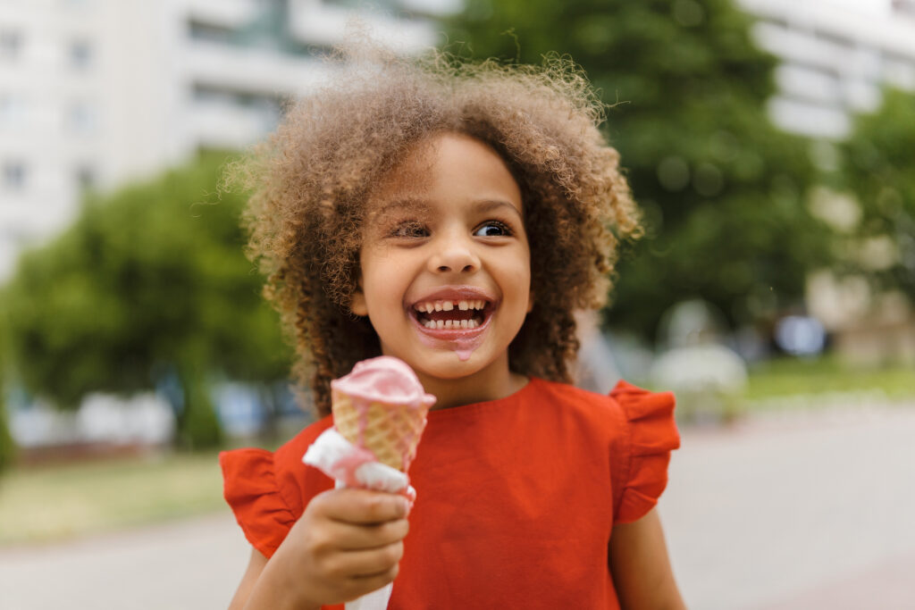 Happy little girl holding ice cream cone - ice cream in NYC