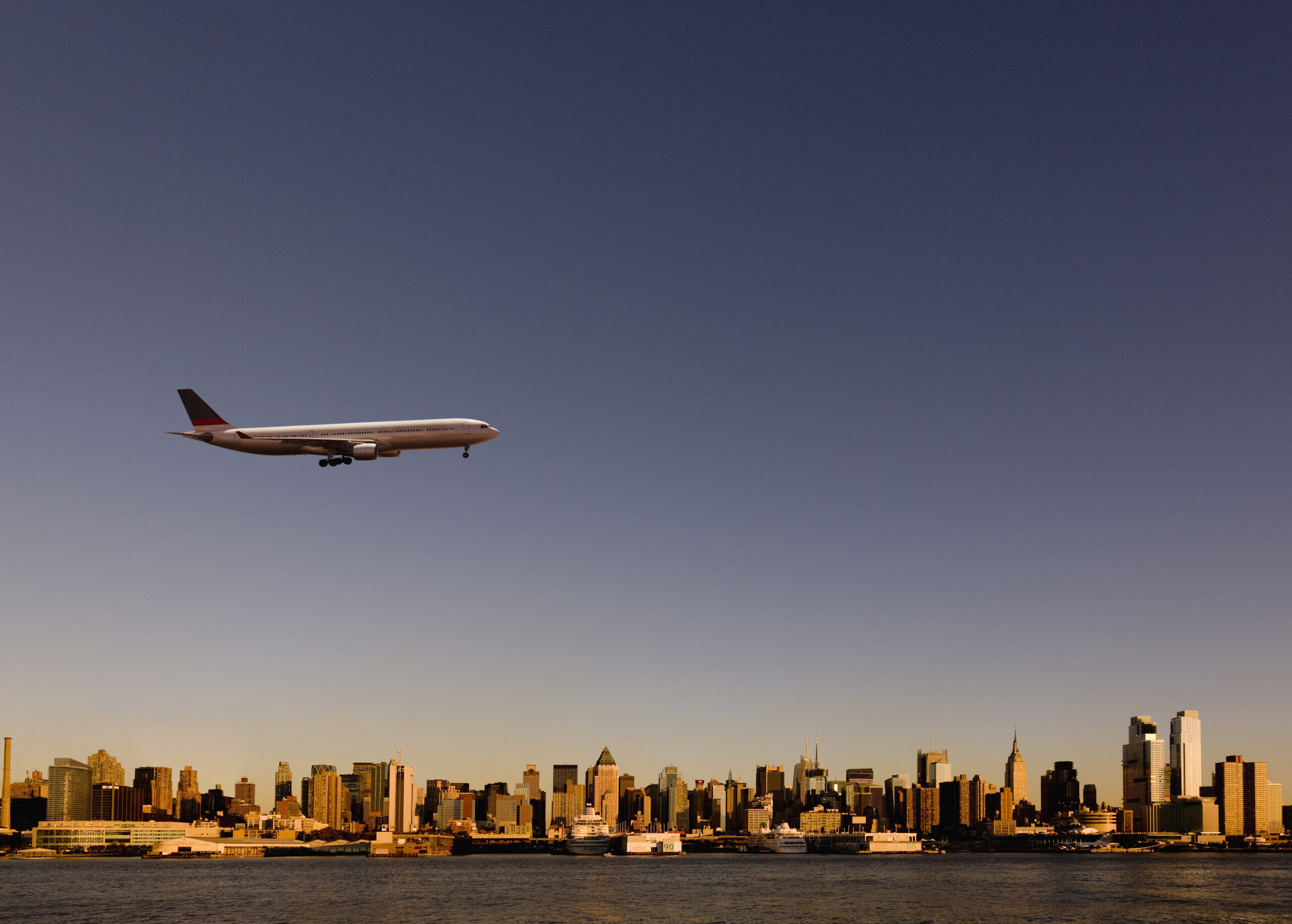 plane flying over NYC - apartments near JFK