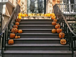 jack-o-lanterns line the stoop of a brooklyn brownstone - nyc halloween neighborhoods