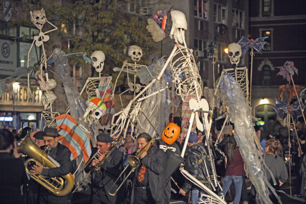Musicians and skeletons fill the streets during the Village Halloween Parade - NYC halloween neighborhoods