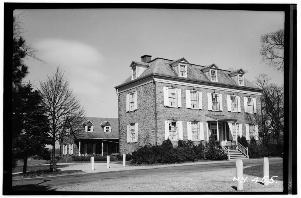 A black-and-white photo of the Van Cortlandt House Museum, also known as the Frederick Van Cortlandt Mansion.