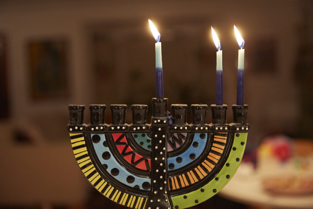 Lit menorah to celebrate hanukkah - decorate your nyc apartment for holidays