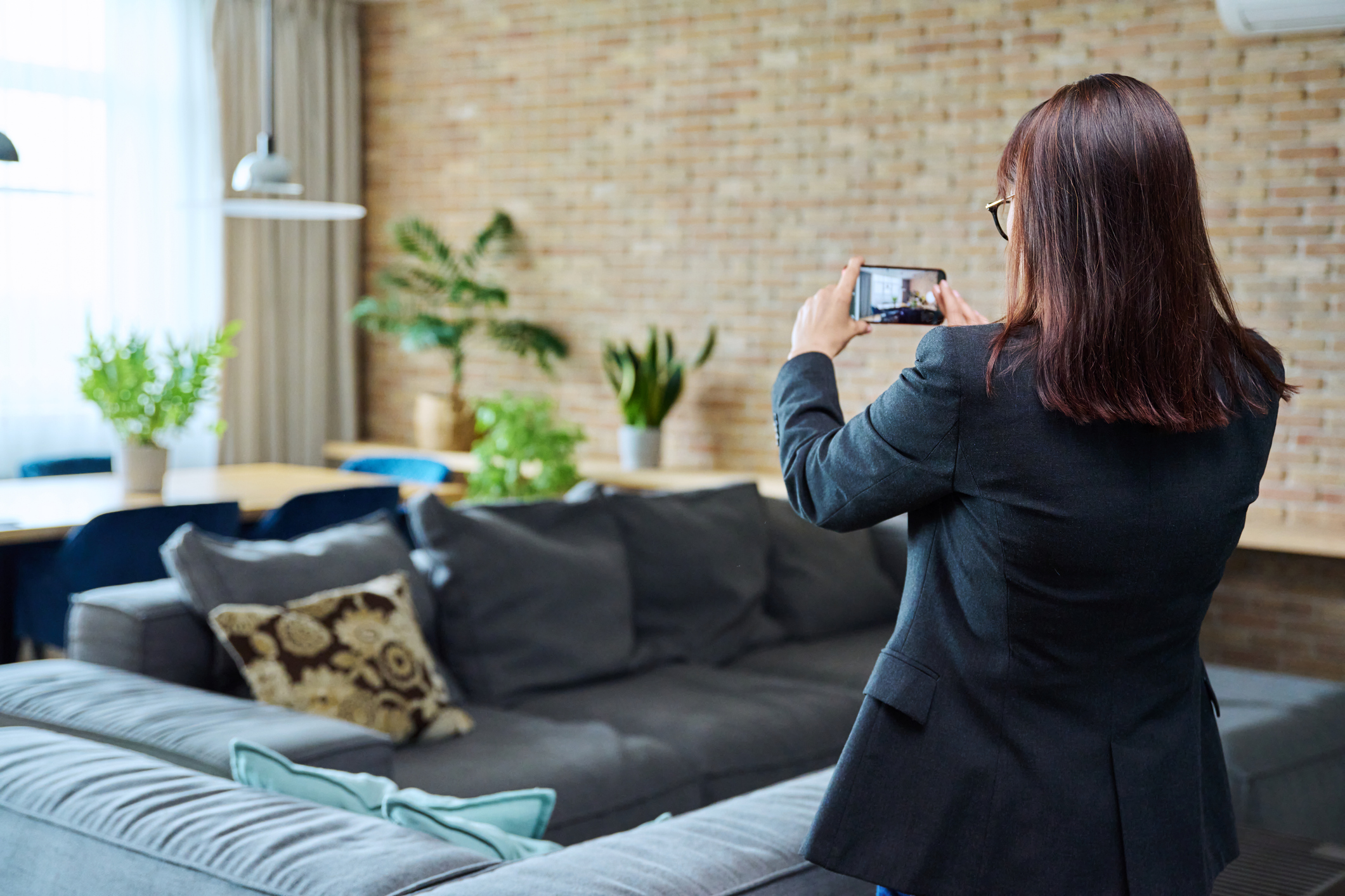 Person taking photos of home while attending an open house