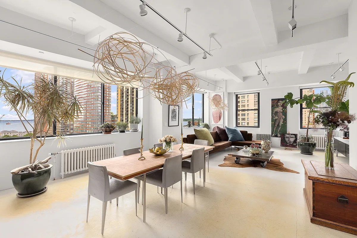 dining room and living room with Hudson views in FiDi loft