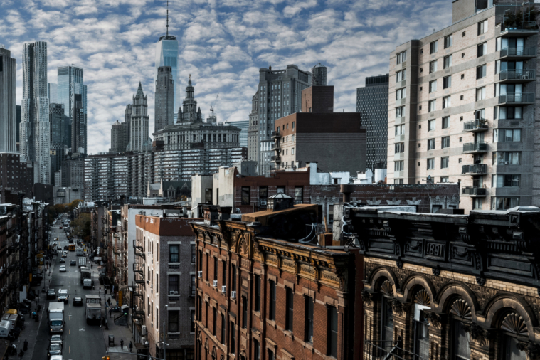 Lower Manhattan apartment buildings with the skyline behind - FARE Act what to expect