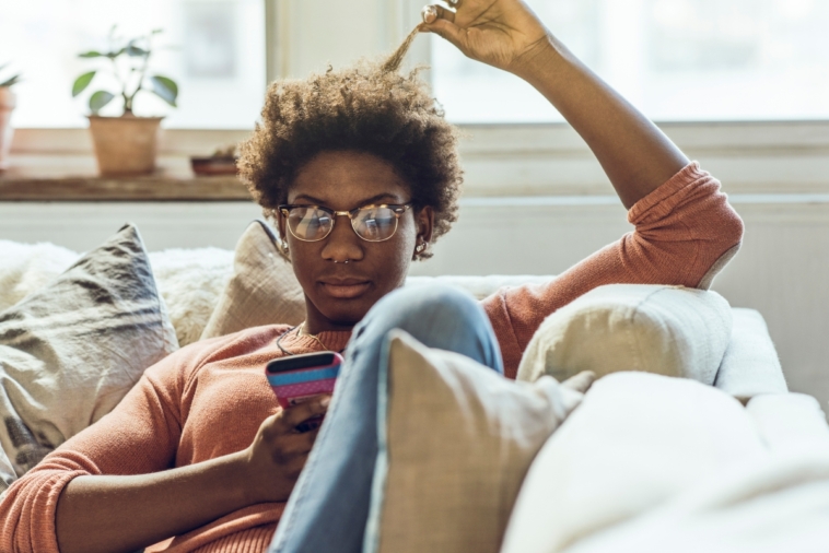 Person sitting on a couch using a phone