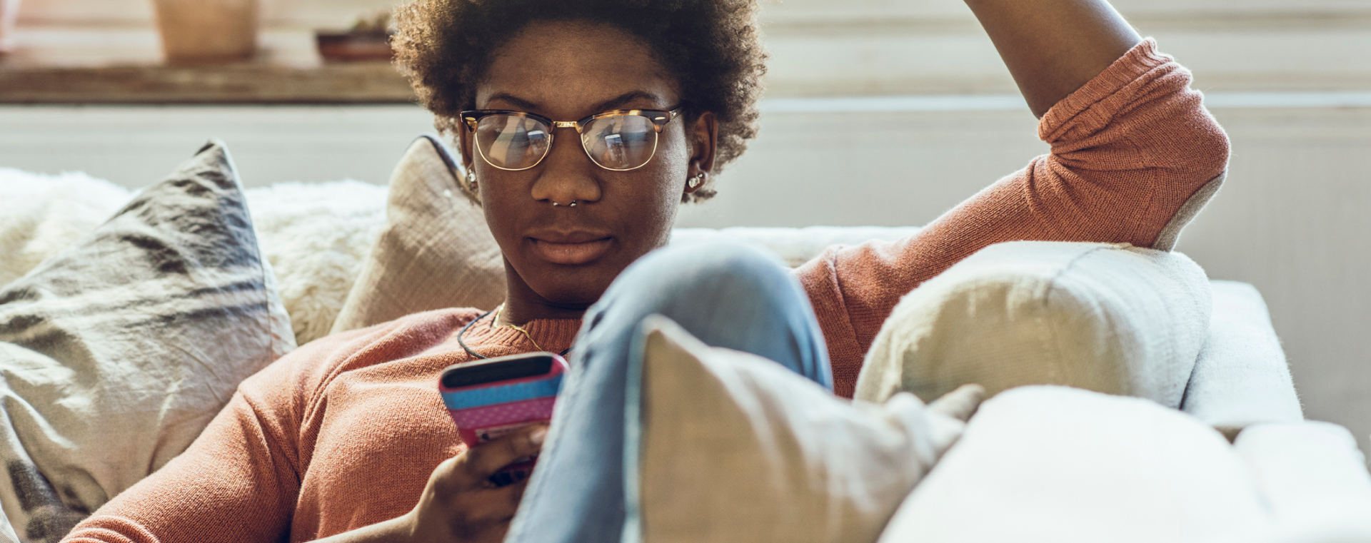 Person sitting on a couch using a phone