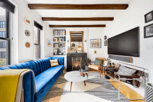 living room with blue couch and fireplace in 1-bedroom in the West Village