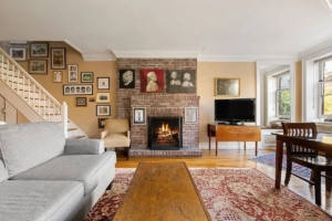 living room with wood-burning fireplace and staircase in Upper West Side townhouse