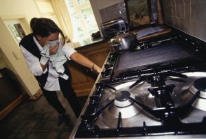 image of woman at gas leak stove