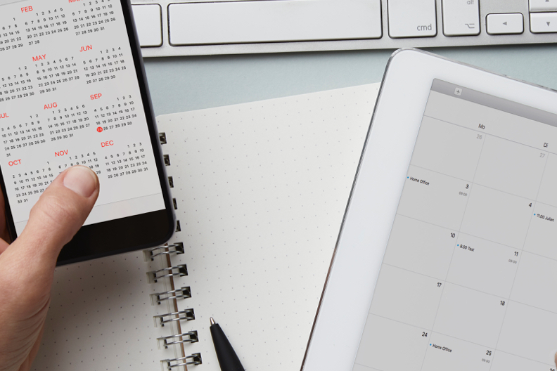 image of someone looking at a calendar on their phone selling and buying a home at the same time