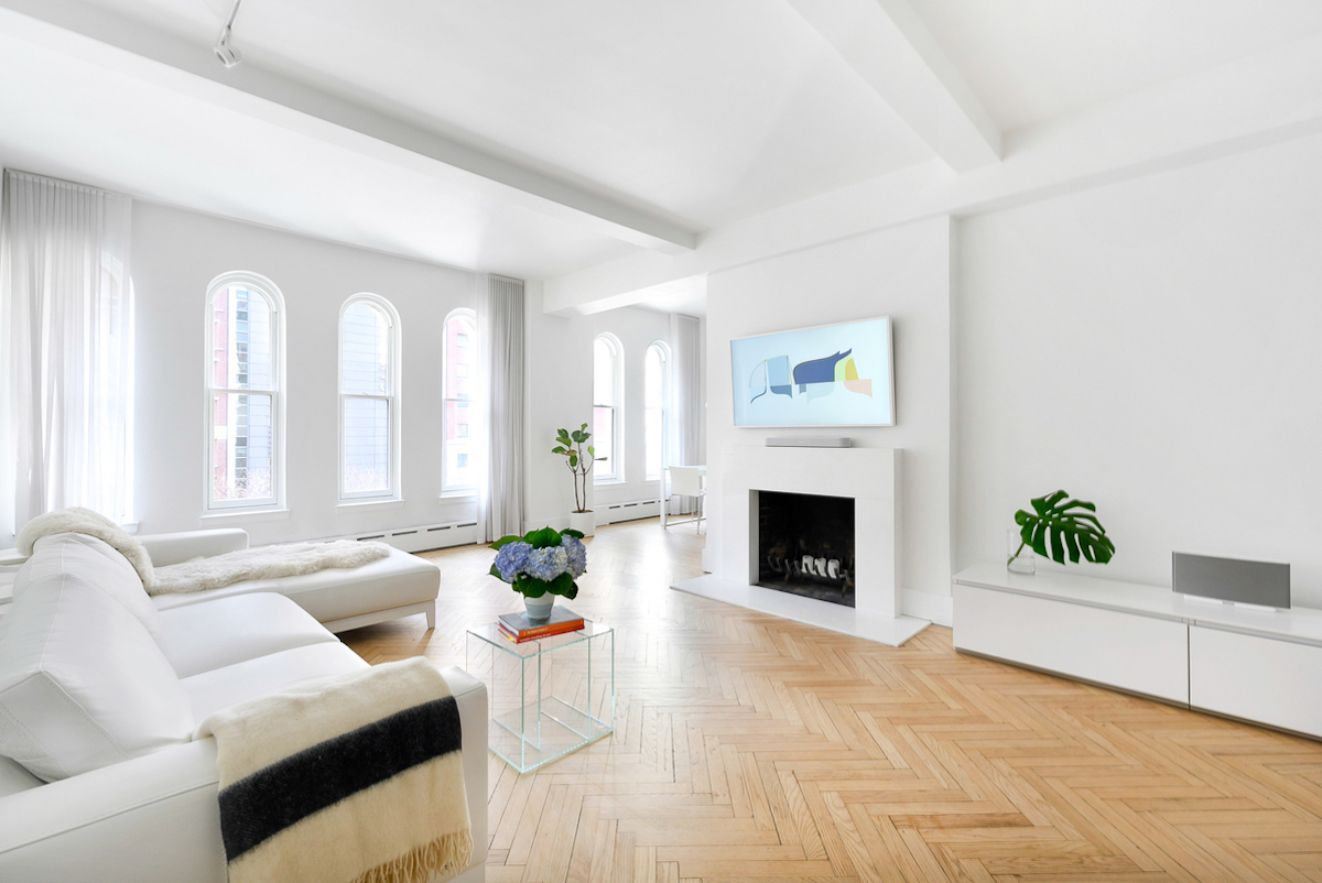 spacious apartment living room with white walls and natural light what is a pied-à-terre