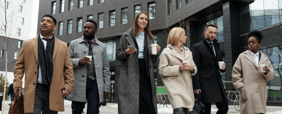Co-workers walking and taking a coffee break