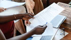 Three people looking over documents