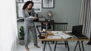 Woman on phone looks through documents