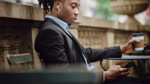 Businessman with coffee looking at phone