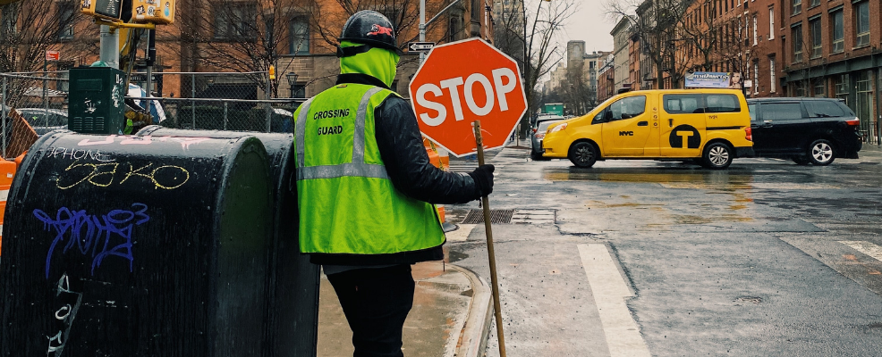 Worker in New York City holding stop sign