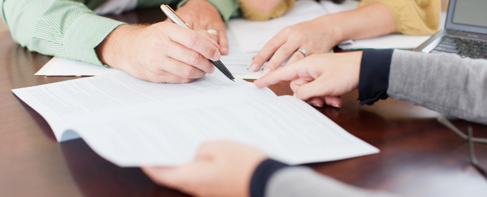 Three people going over documents