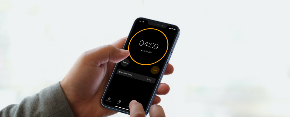 Person sets timer on iPhone