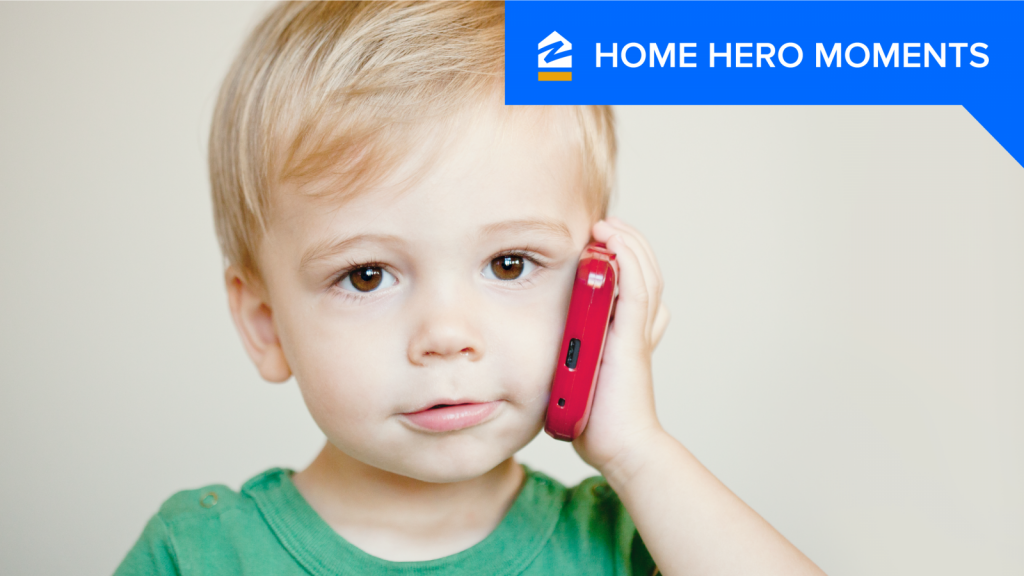 Toddler holds a cell phone to his ear