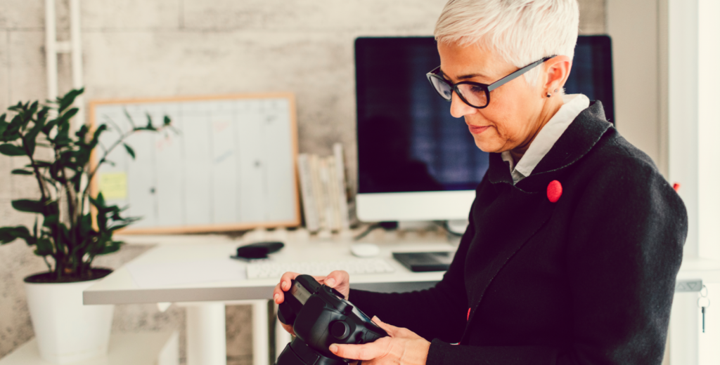 An agent making adjustments to a camera according to tips for real estate photography.