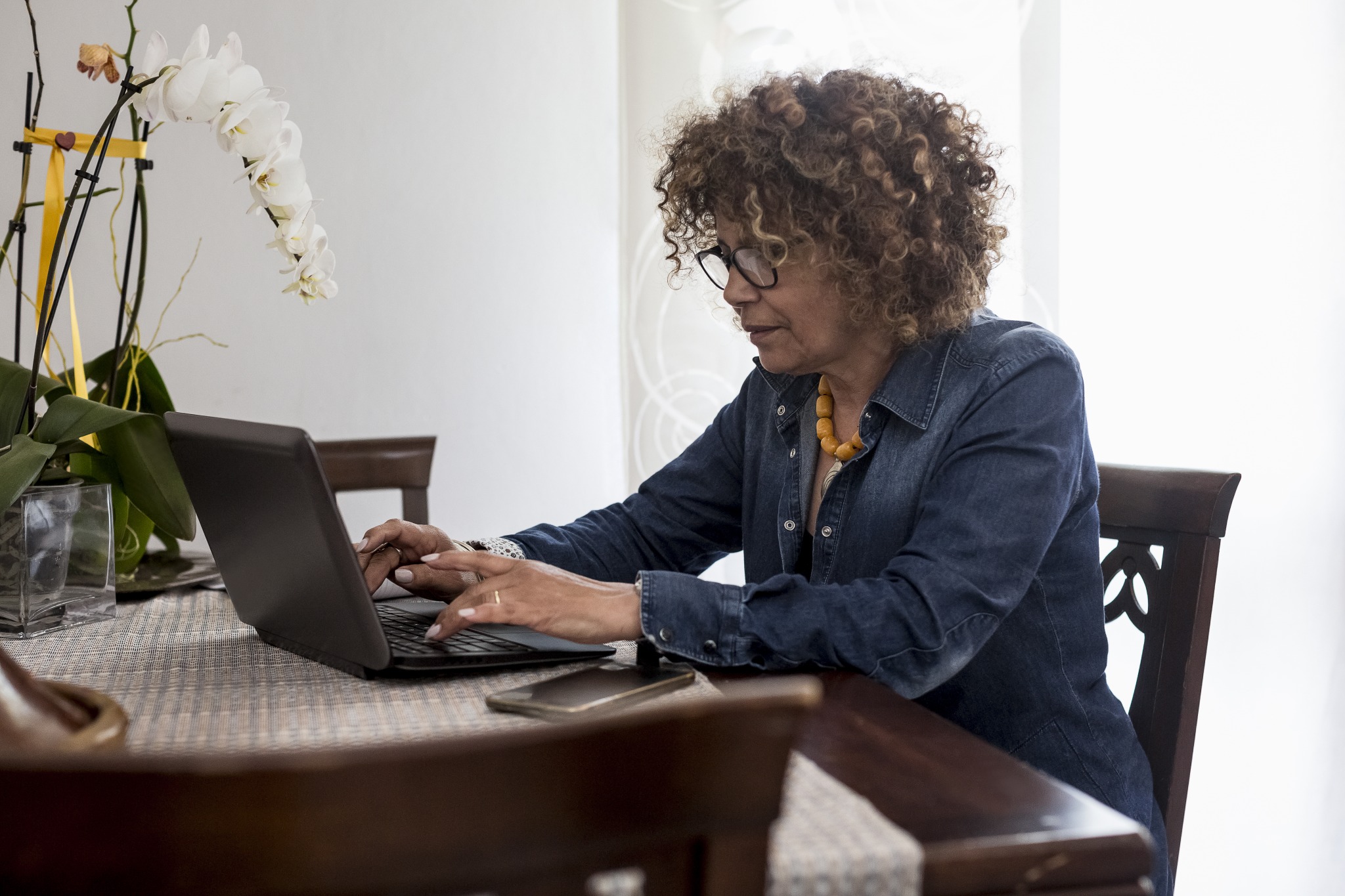 A landlord writing a lease termination letter on her laptop.