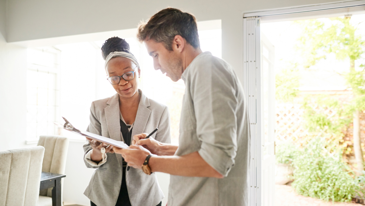 A home buyer signing a purchase agreement.