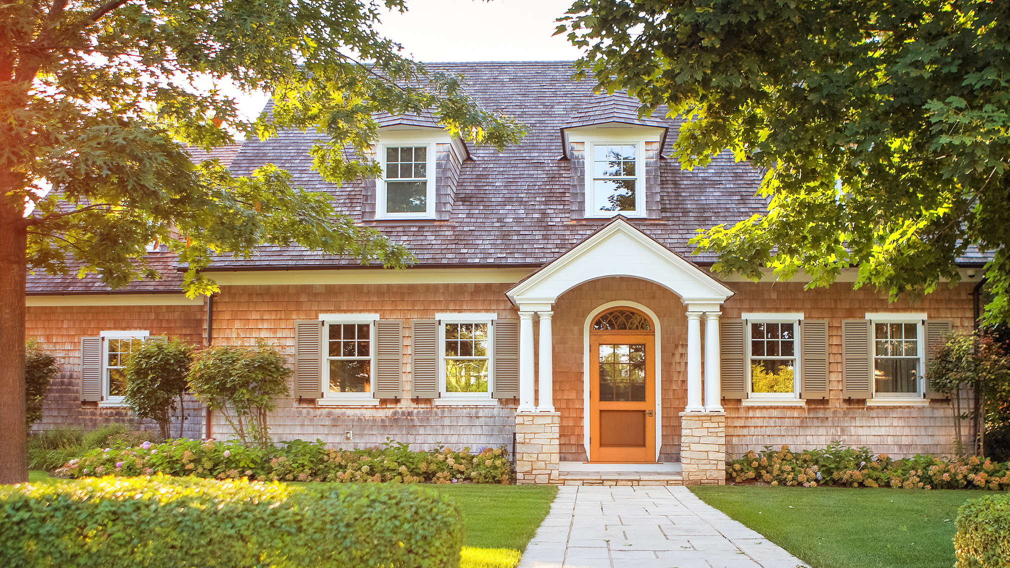 A traditional brick home with welcoming front walkway.
