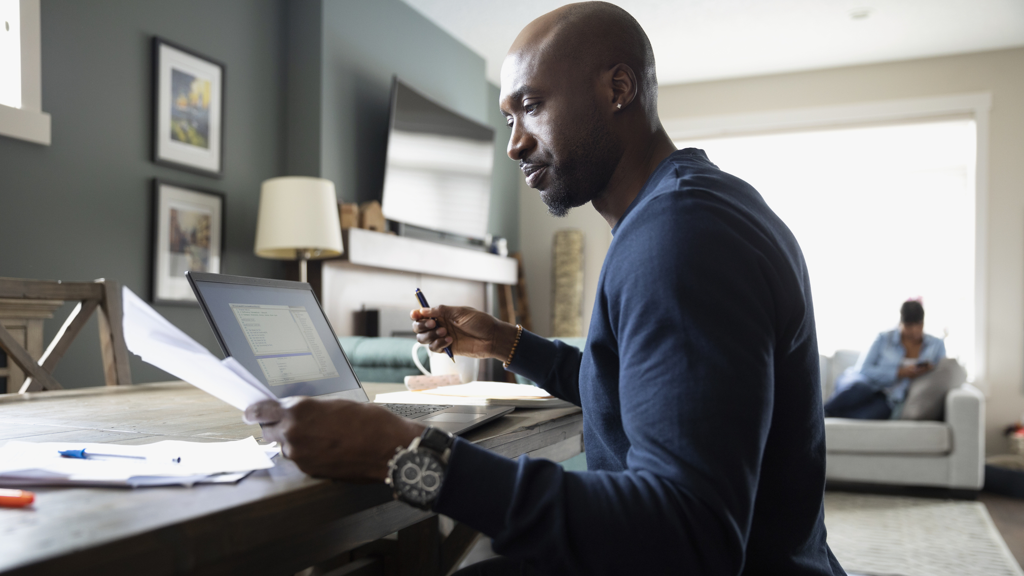 A man learning about mortgage insurance at a laptop.