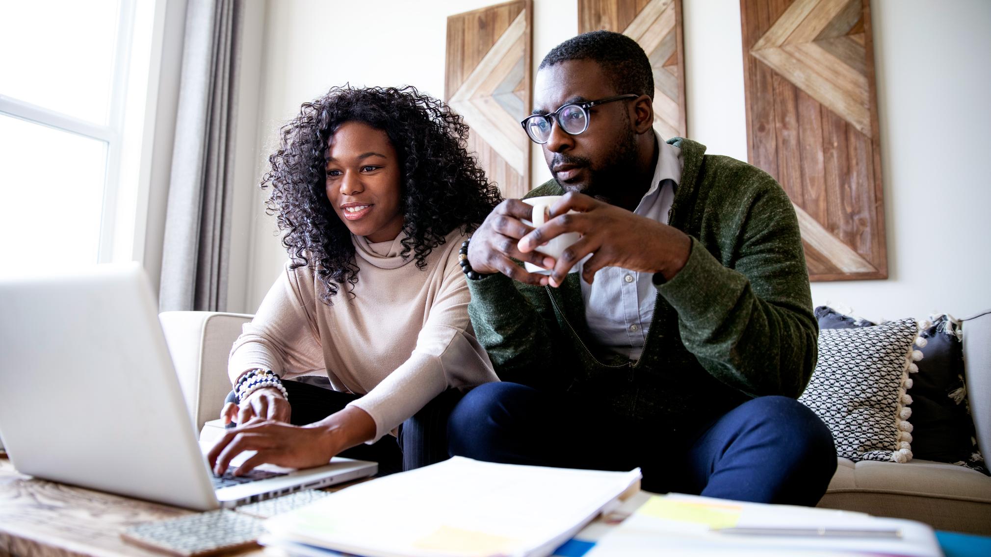 A man and a woman shopping for a mortgage online.