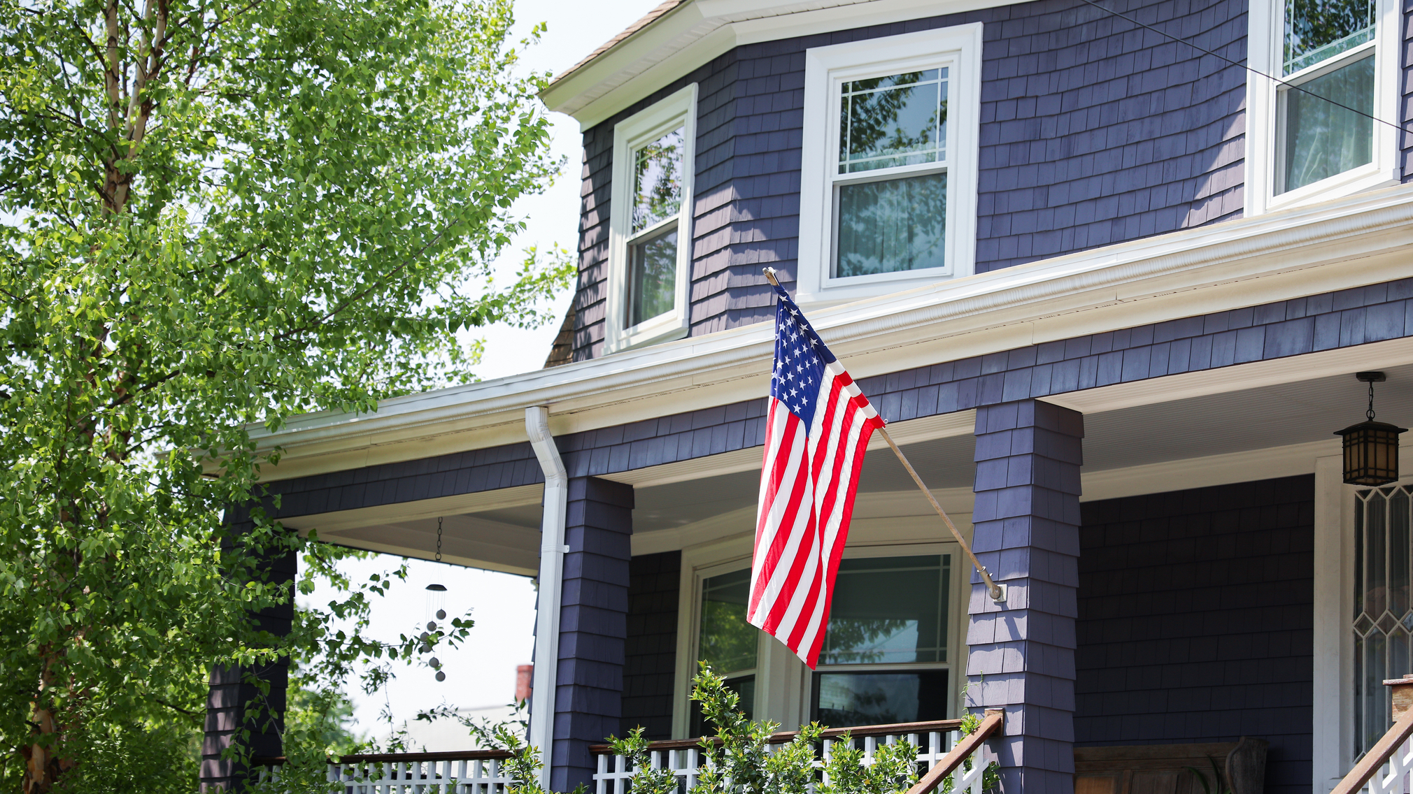 US flag proudly displayed in front of an American house symboliz.