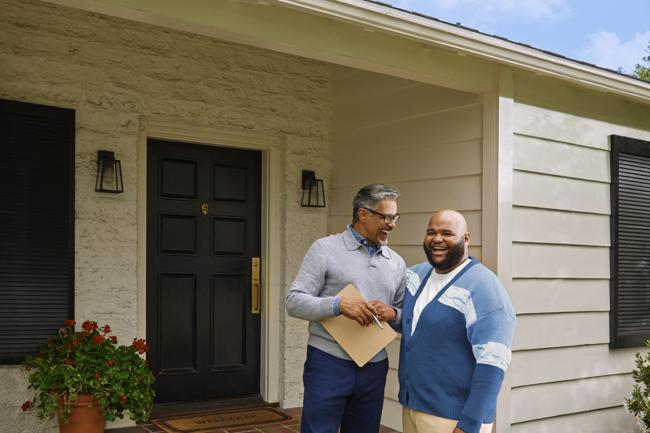 A buyer with his agent after winning a house bidding war.